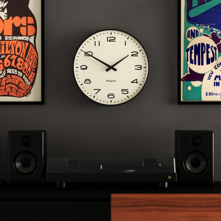 A retro-style wall clock with a matt black case and black arabic dial
