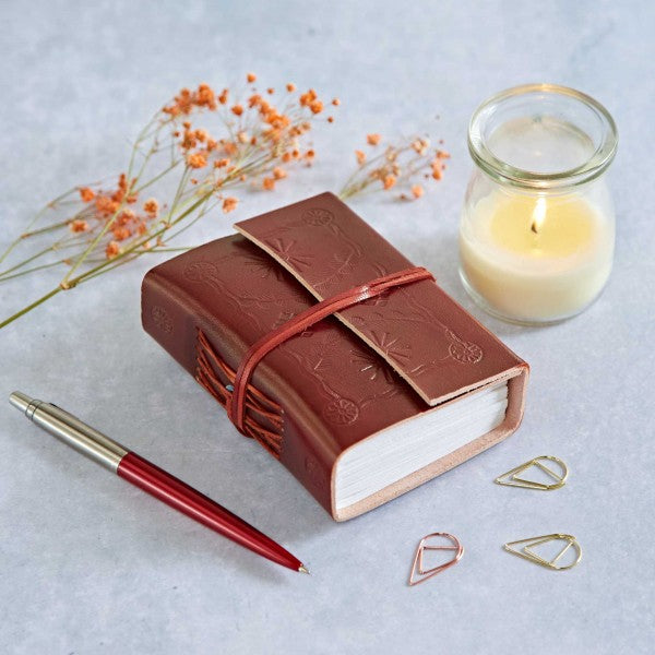 Embossed leather journel, brown color with a leather string to tie the book