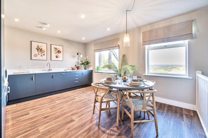 Spacious dining room with teak chairs and fruit art prints Uneeka & Stags Estate Agents