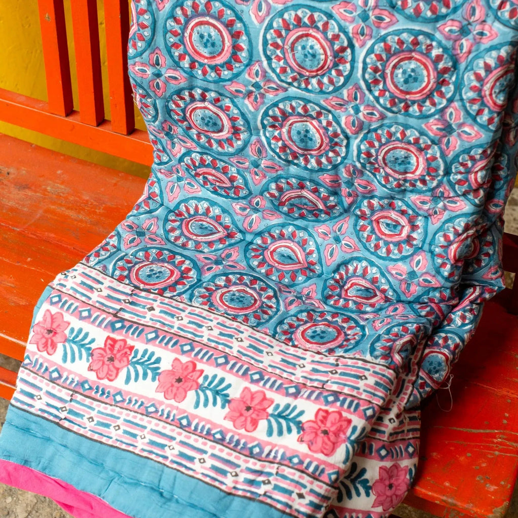 Single Blue & Deep Pink Block Print Quilt displayed on chair