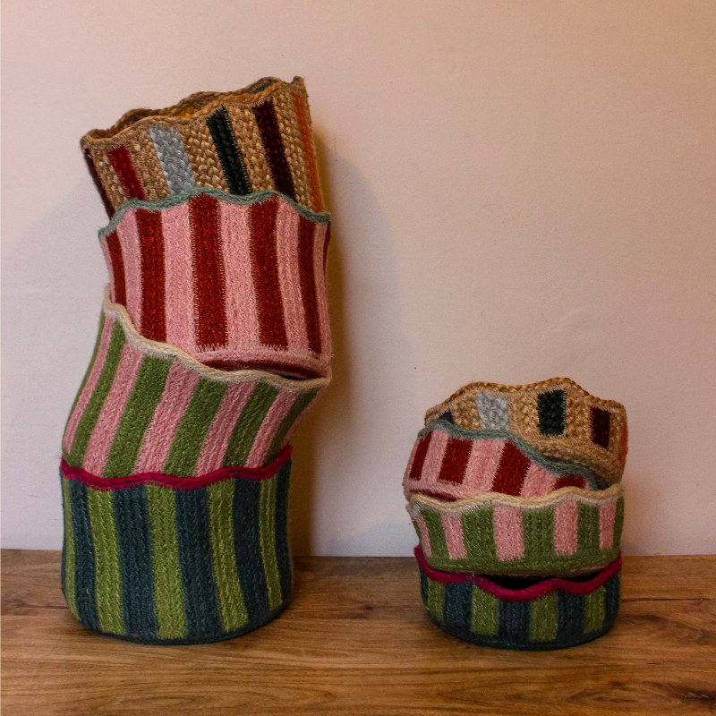 Colourful Jute Baskets with striped patterns on a wooden surface at Uneeka