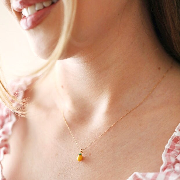 Tiny Coloured Enamel Lemon Charm Gold Necklace being worn