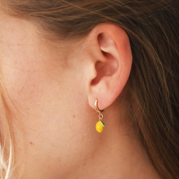 Tiny Coloured Enamel Lemon Huggie Hoop Earrings being worn