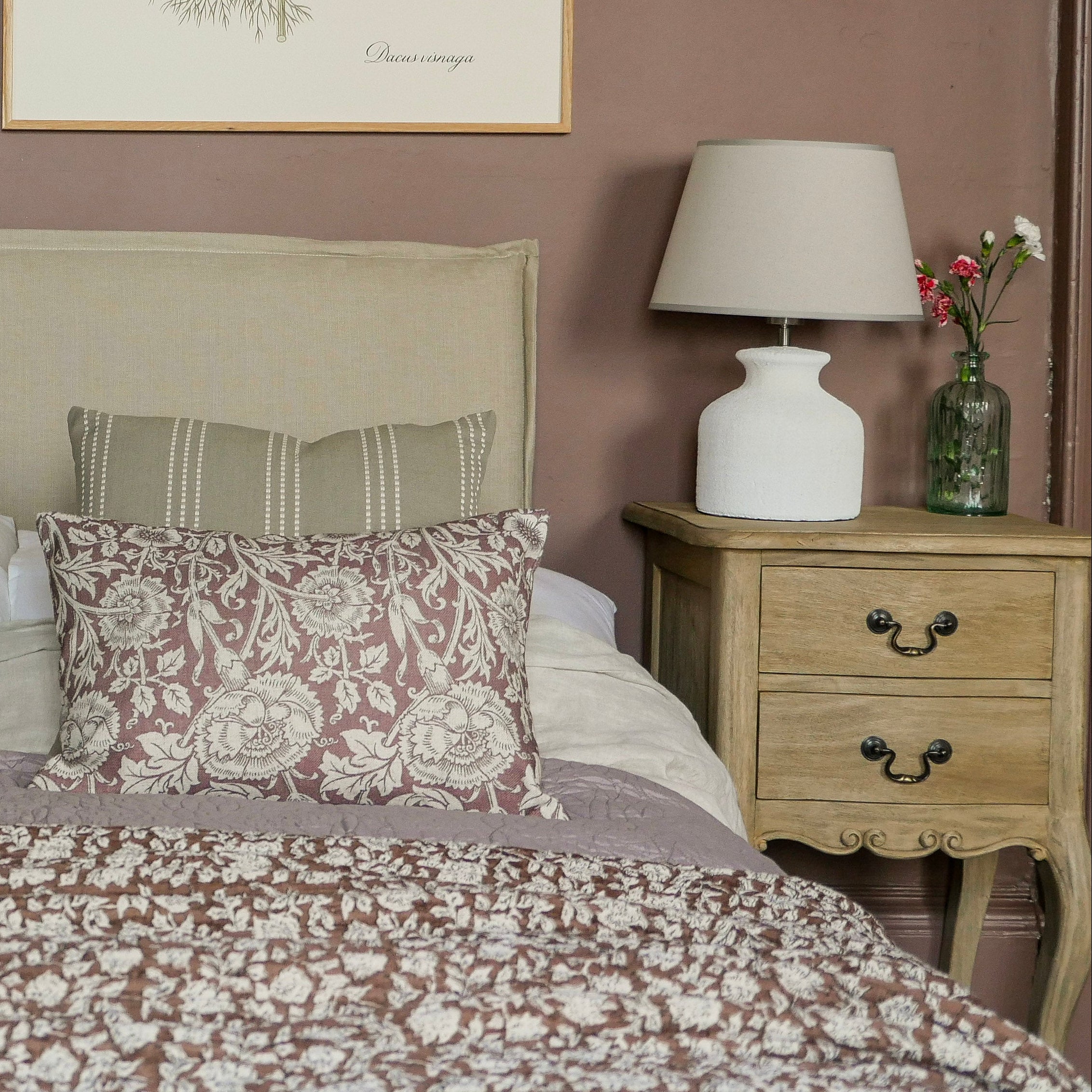 Bedroom with floral bedding, matching pillows, and two lamps on nightstands. Vintage 2 Drawer Side Table Uneeka Lifestyle