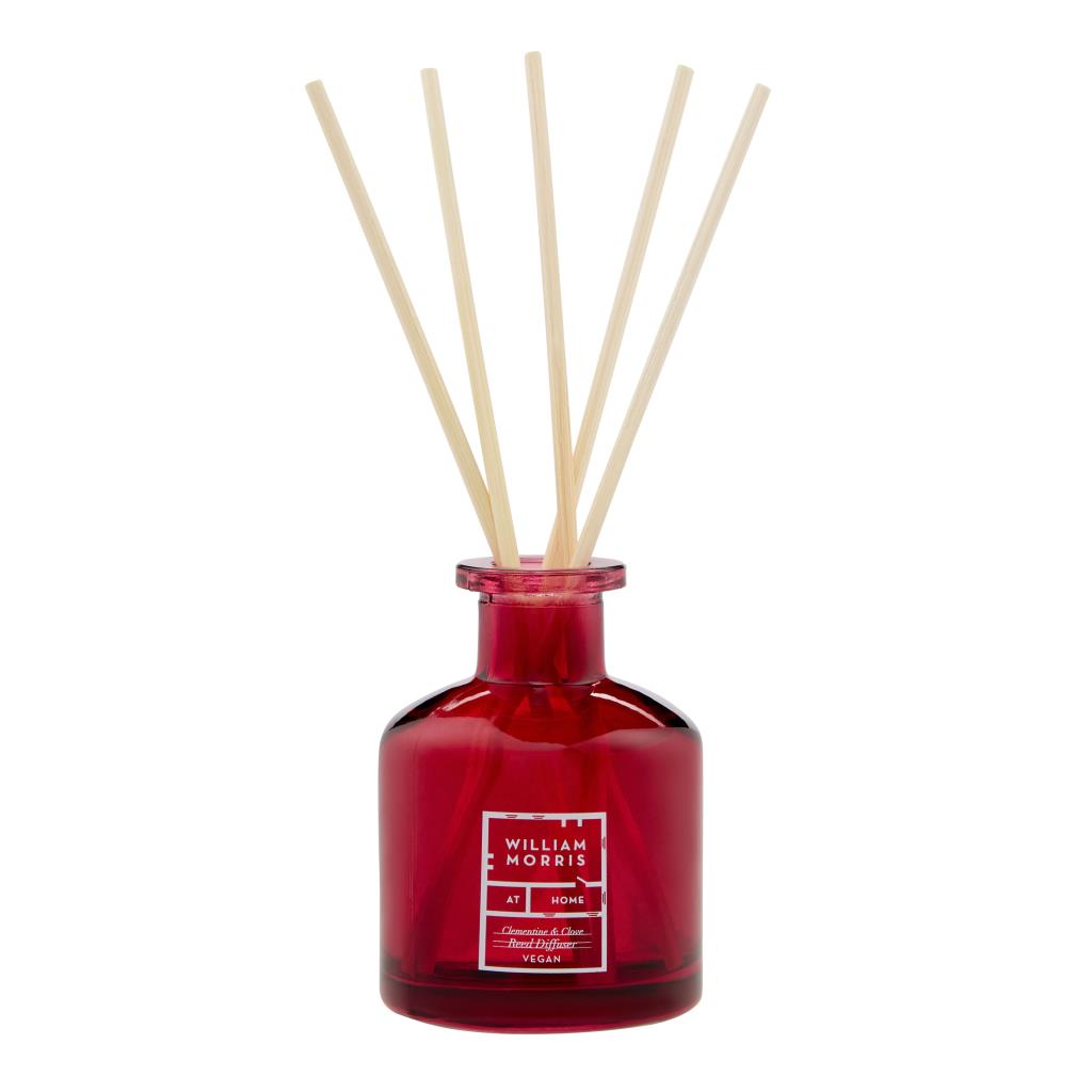 William Morris reed diffuser with a red glass bottle and natural wooden reeds, on a white background.