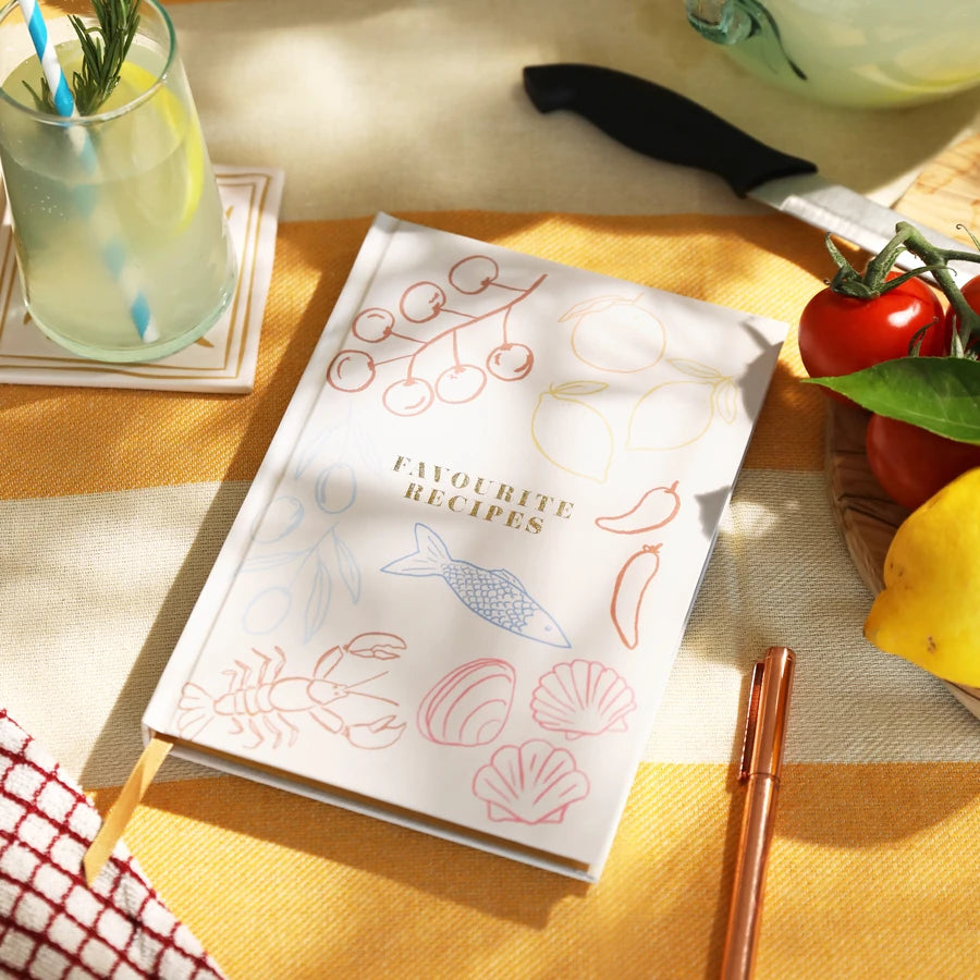 A white hardcover recipe book titled 'favourite recipes' with delicate multicolour line drawings of food items 82837 Uneeka