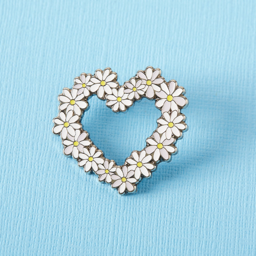 Daisy heart enamel pin, lots of metal daisies arranged to form a heart shape