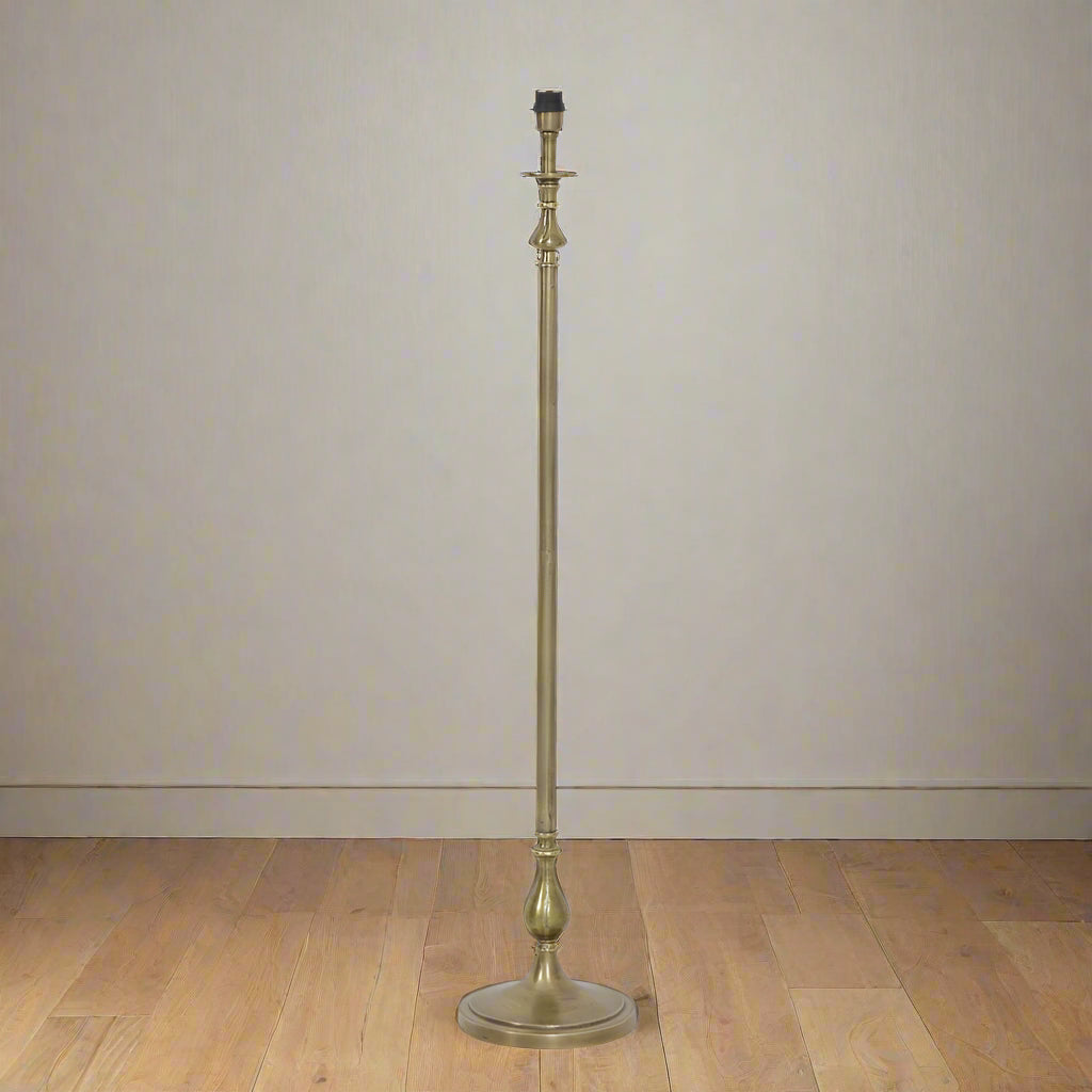 Raw antique bronze lamp Tall and slender floor lamp with curved details.
