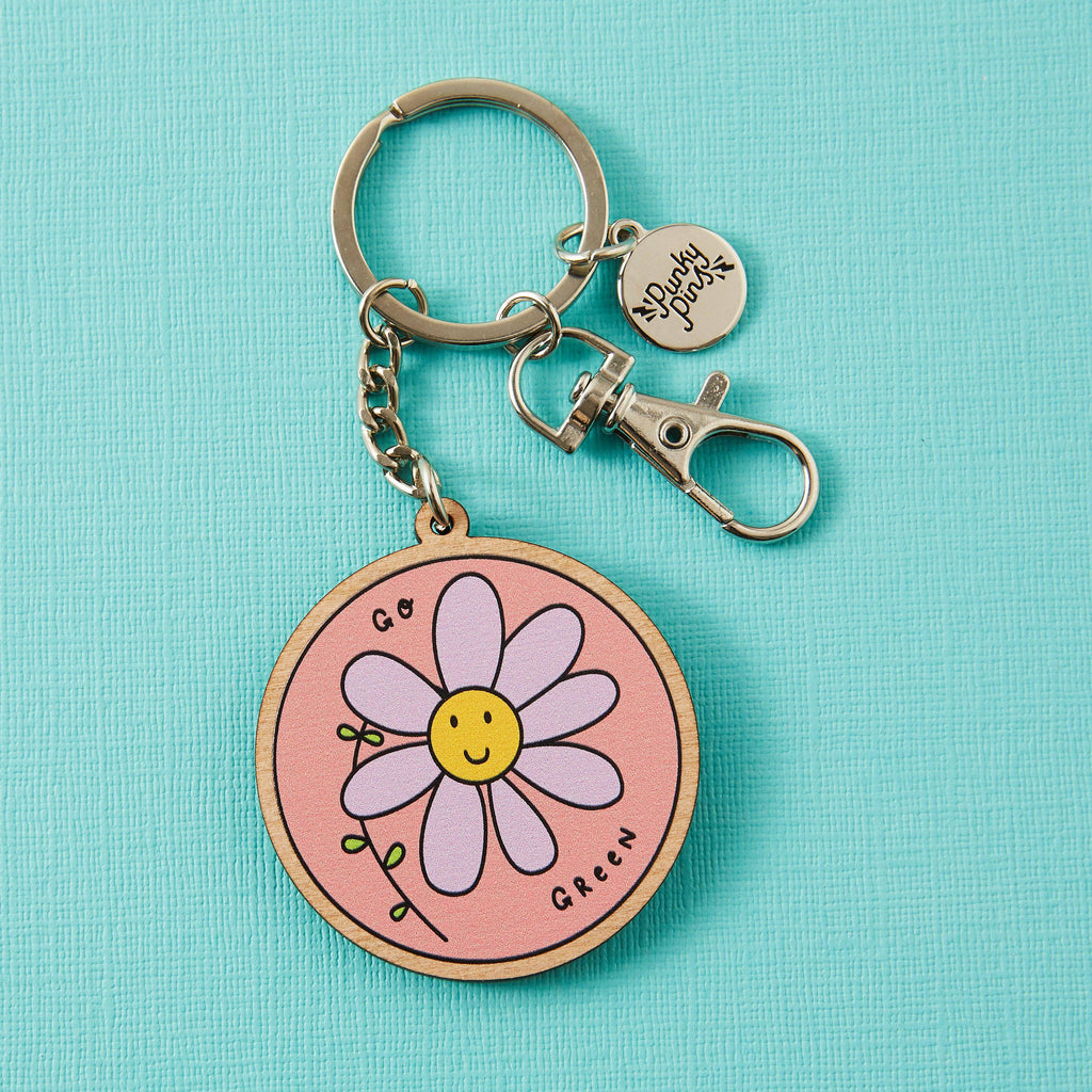 Wodden eco keyring, pink with purple and yellow smily face 